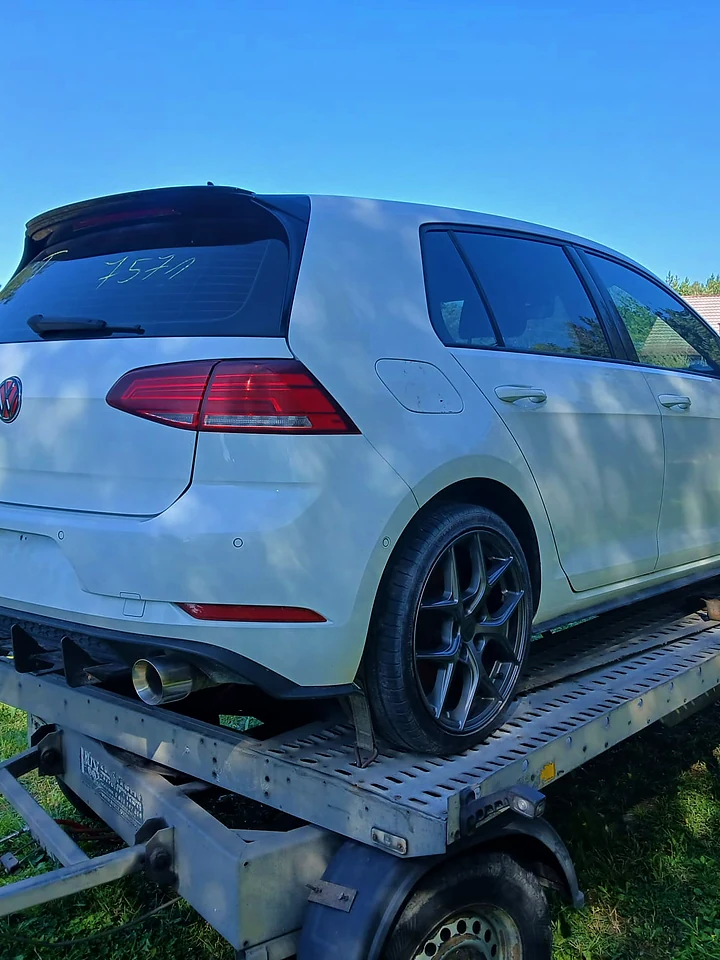 White Volkswagen Golf GTI on a trailer