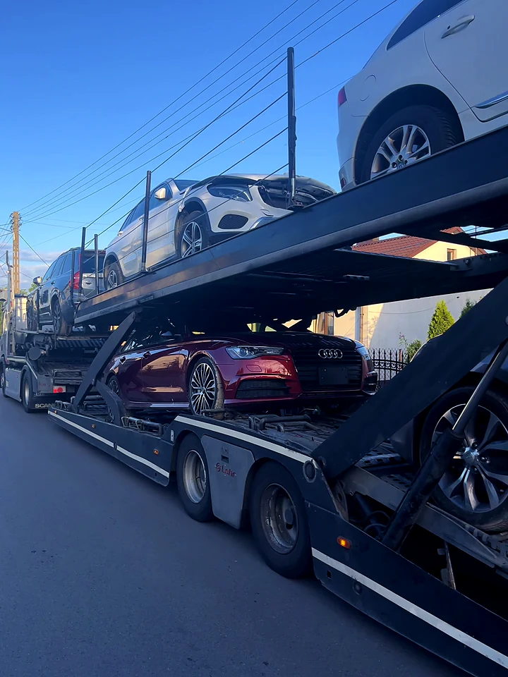 Loaded car transporter with an Audi and SUVs