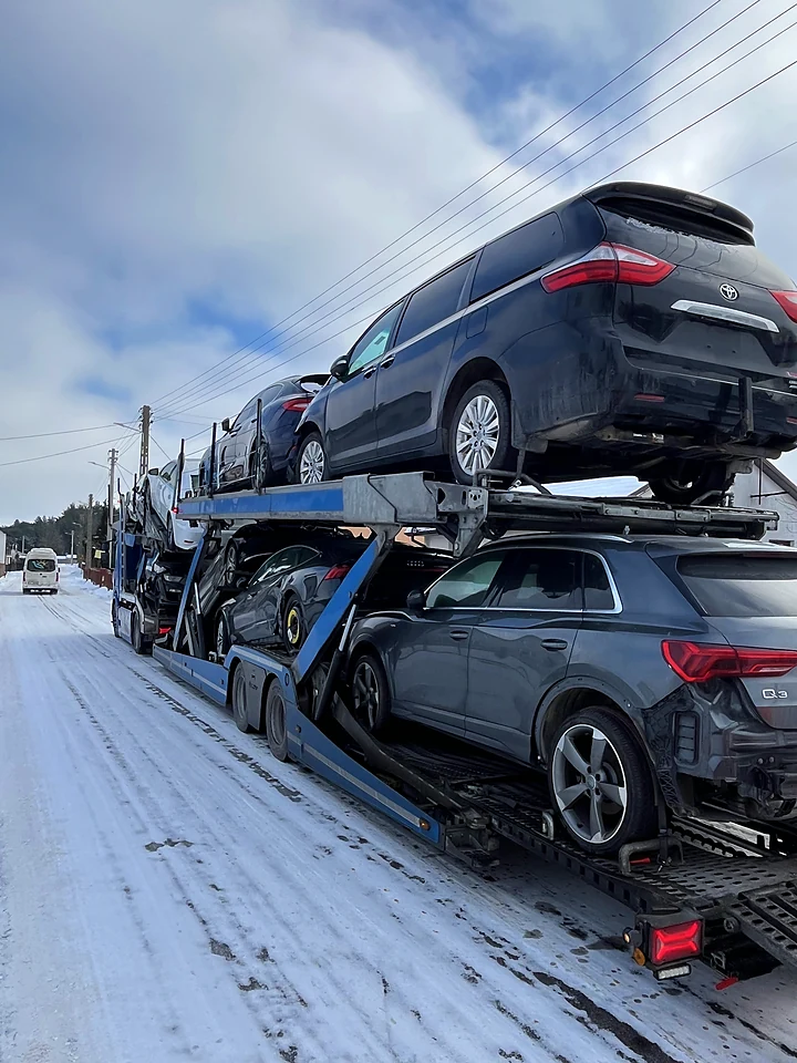 Car transporter on a snowy road