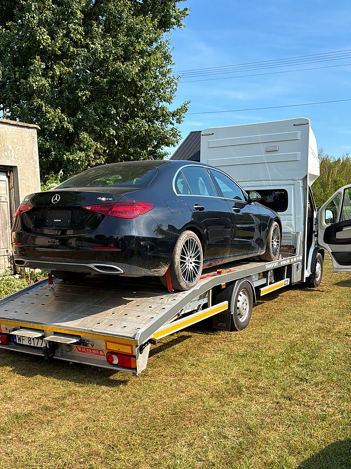 Black Mercedes C-Class on a trailer